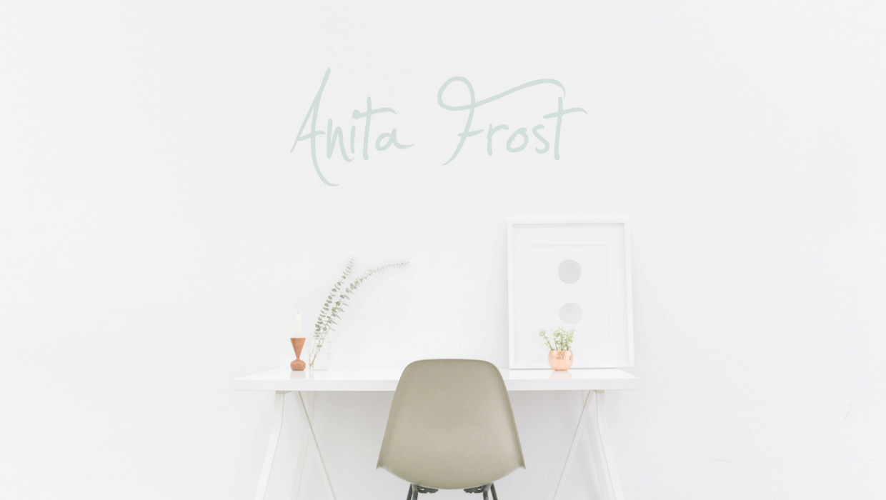 Picture of a desk with Anita Frost logo on